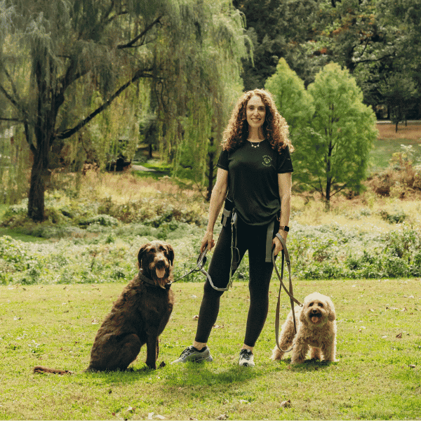 dog gone walking owner posing with dogs during dog walking service